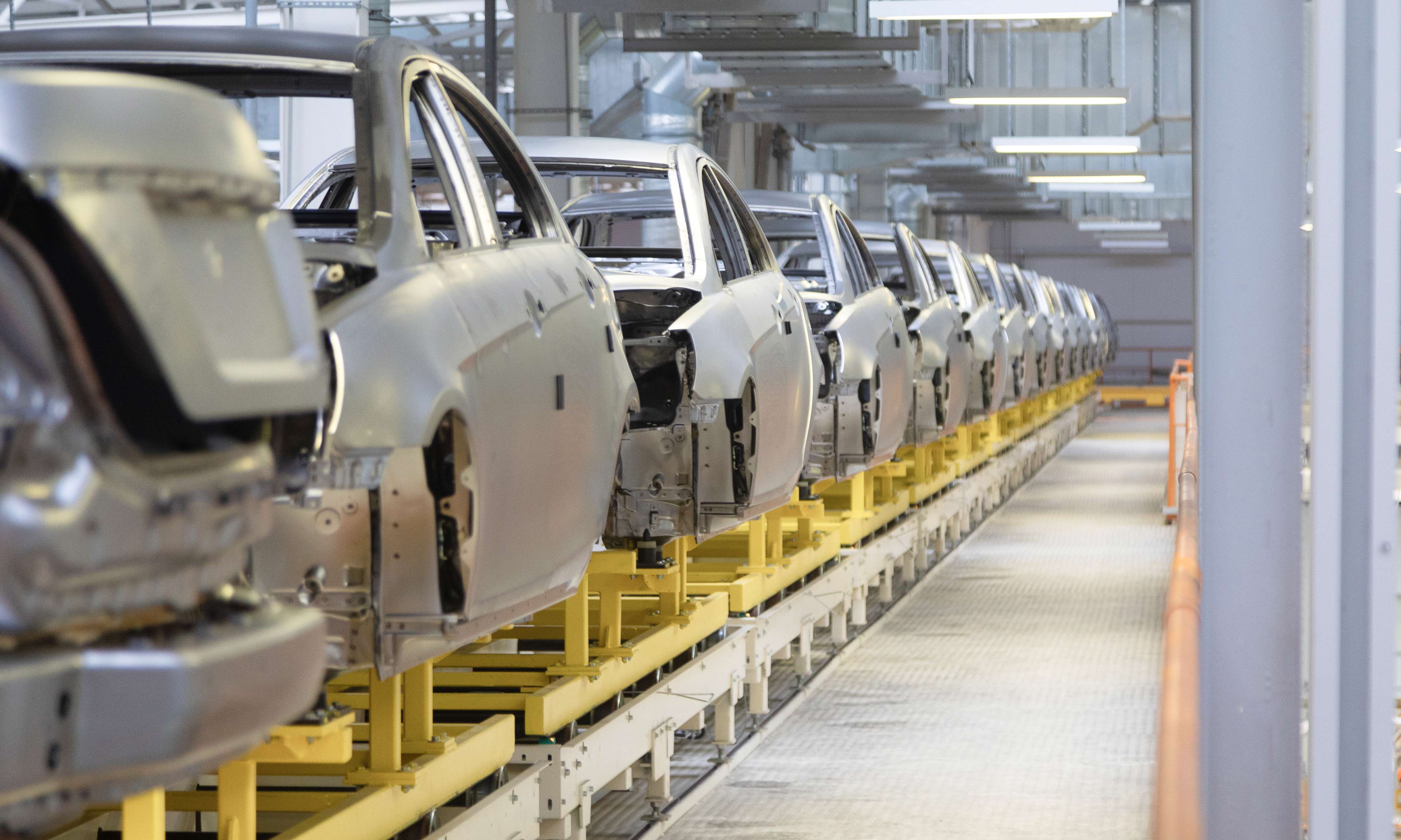 Vehicle bodies moving along an automotive assembly line