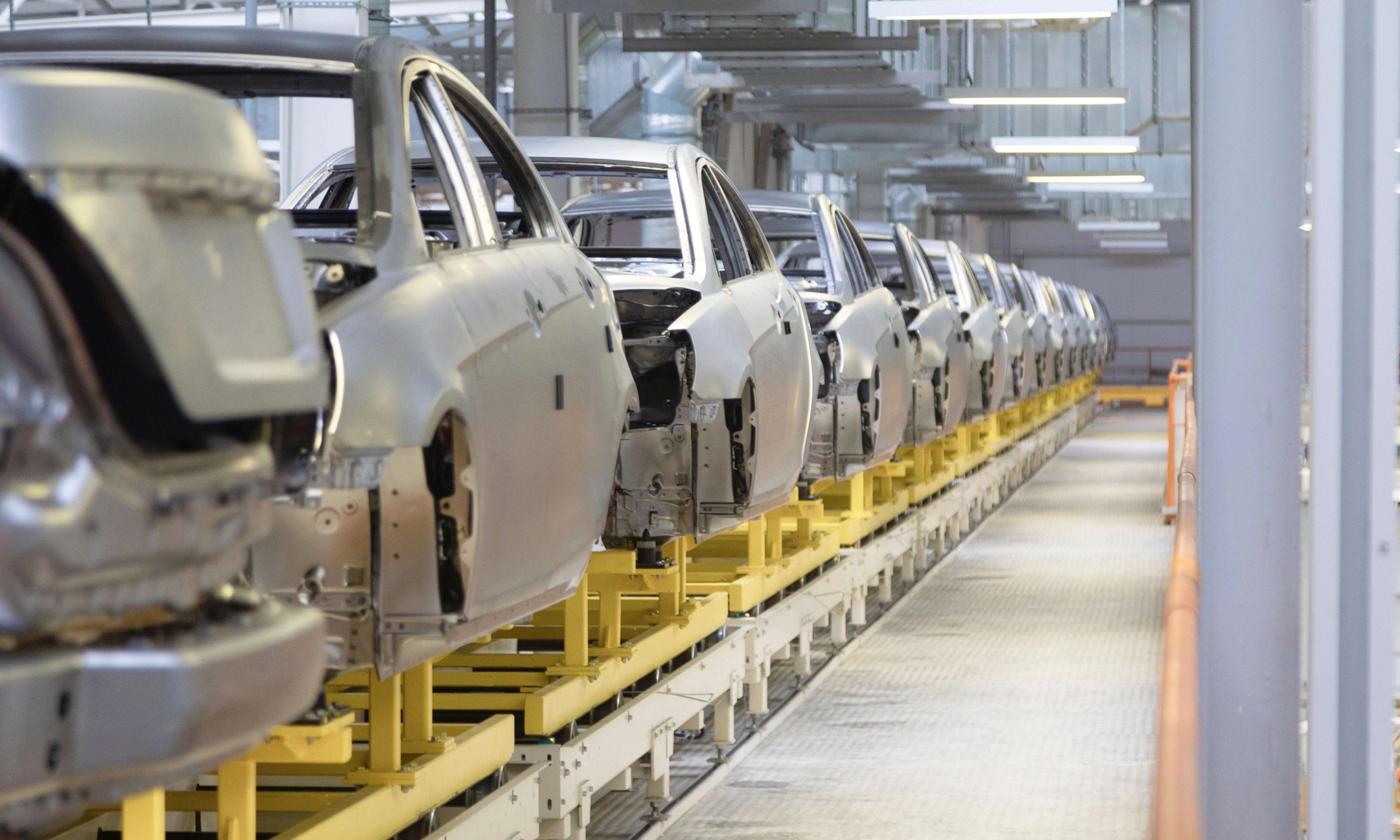 Vehicle bodies moving along an automotive assembly line