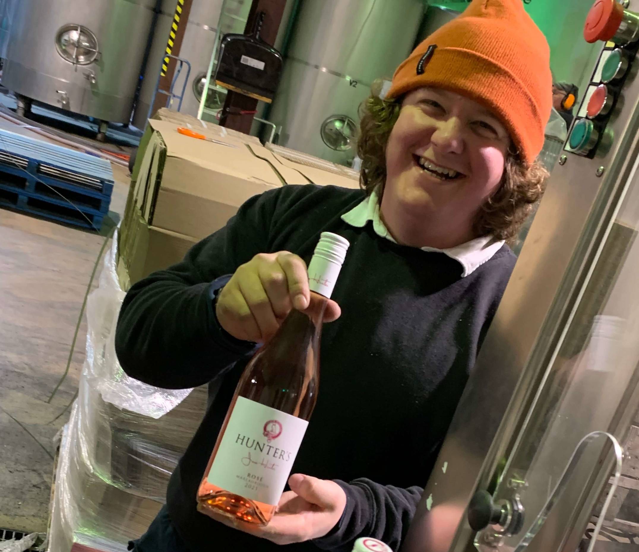 Dan working on the bottling line, posing with a bottle of Rose. 