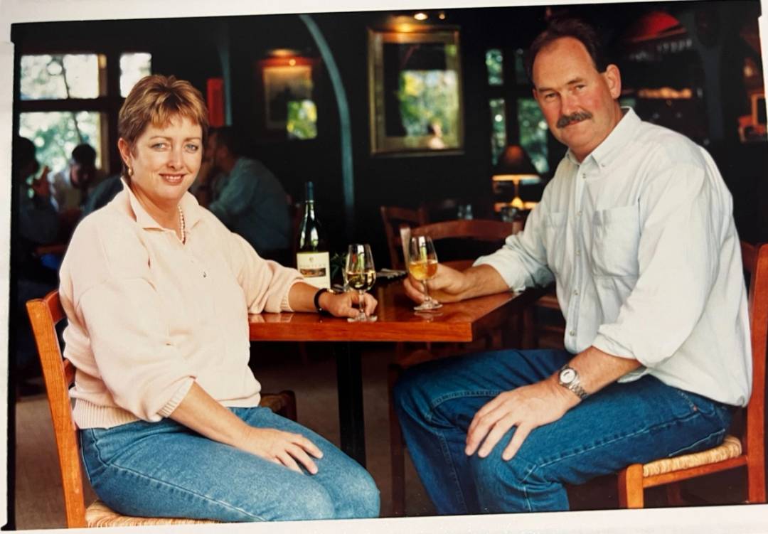 Gary Duke and Jane Hunter sitting at a table posing for a photo