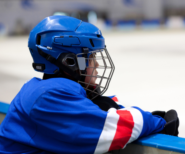 Ice hockey boy watching training