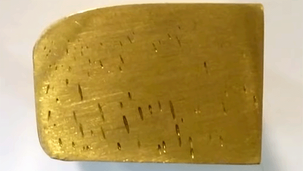 Gold testing pores in gold bar