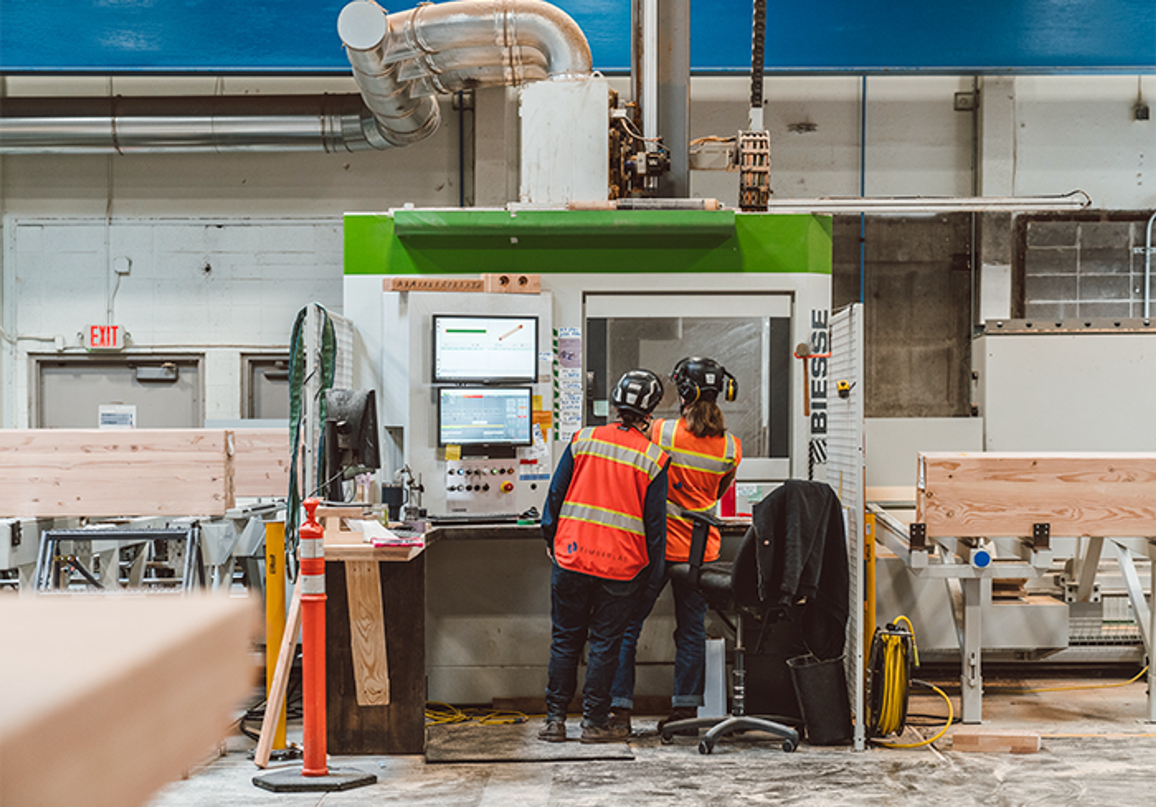 Two workers using machinery