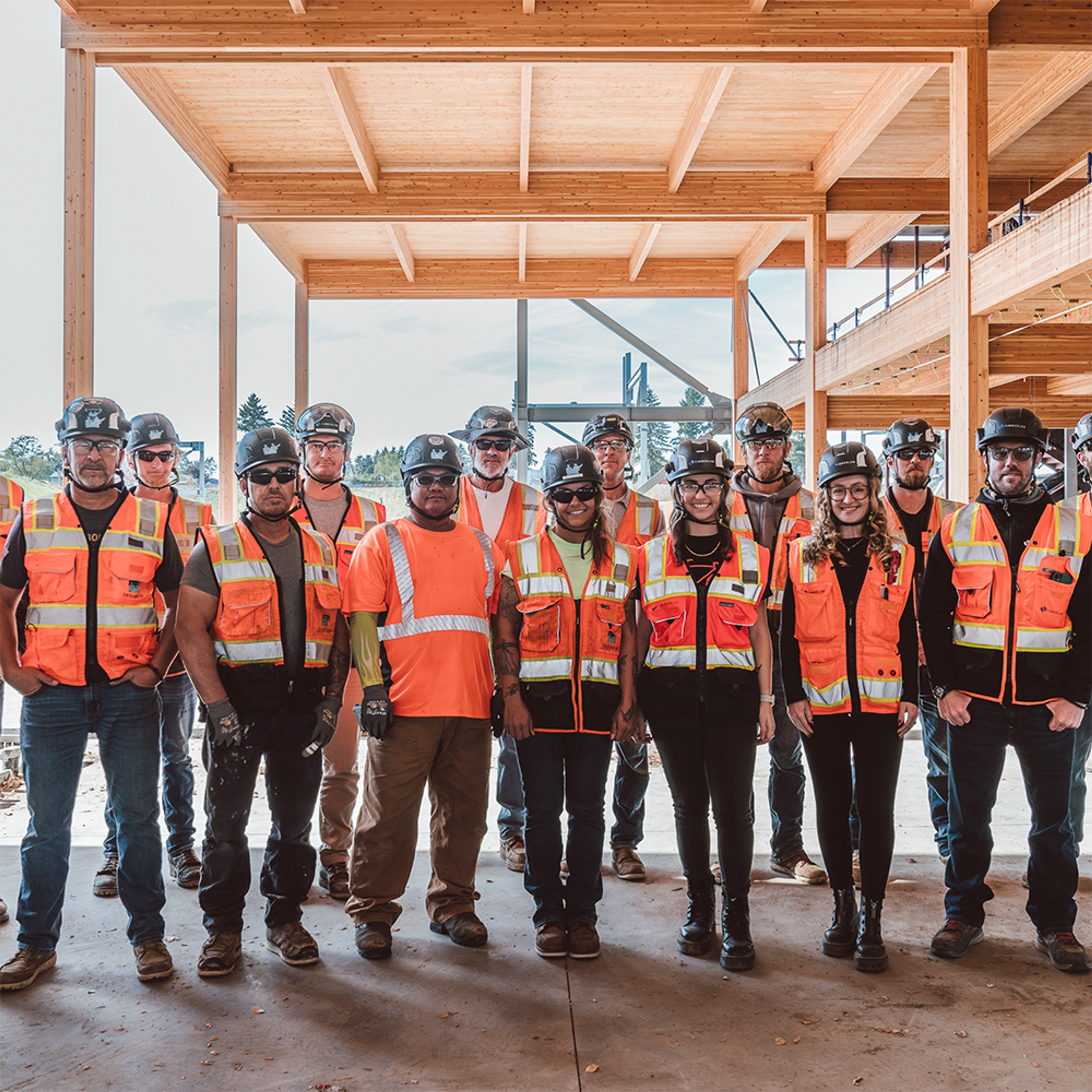 A group of employees standing in front of timber construction