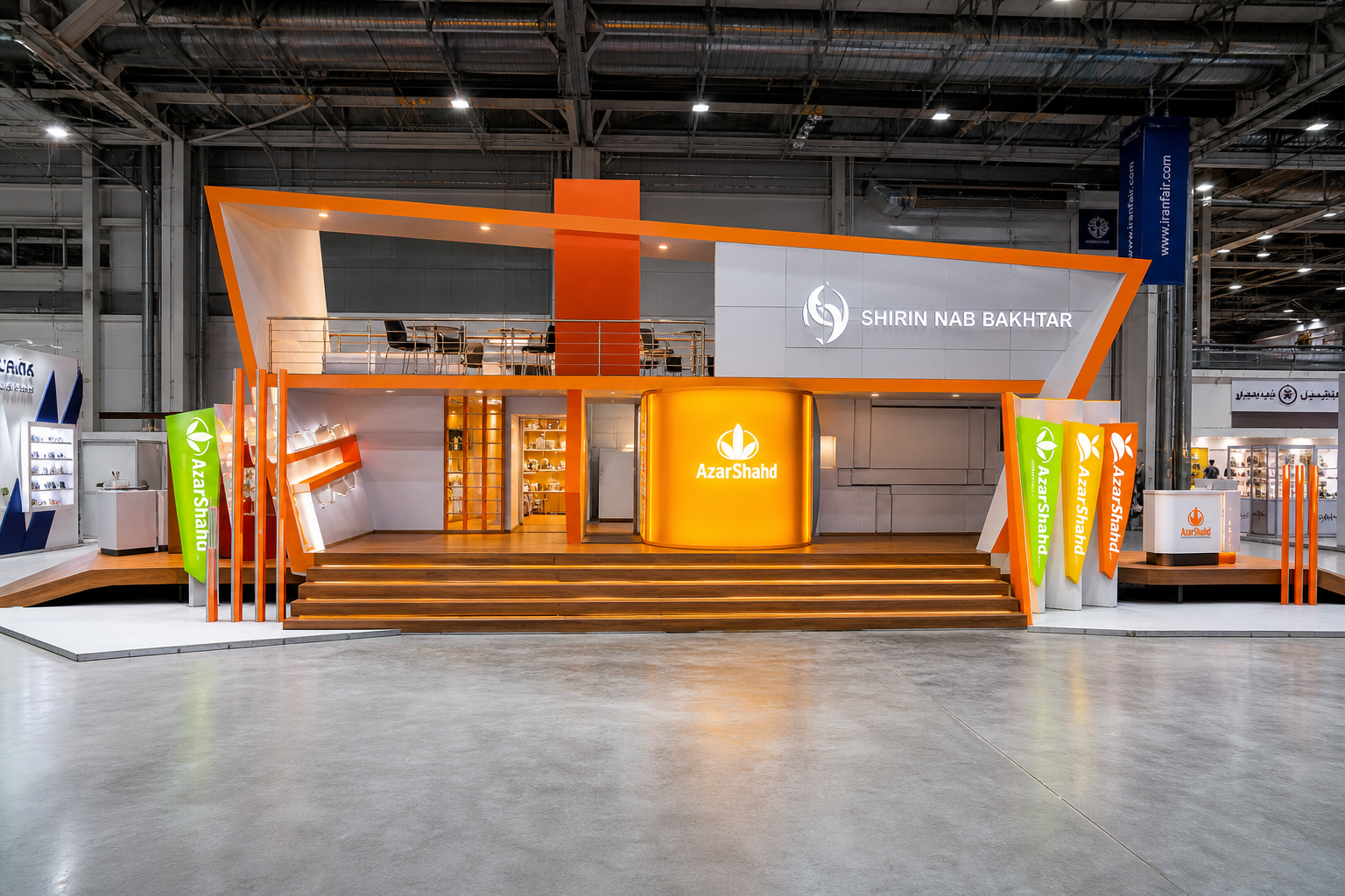 Front view of the AzarShahd exhibition stand with angular orange framing, illuminated branding and a raised meeting level.