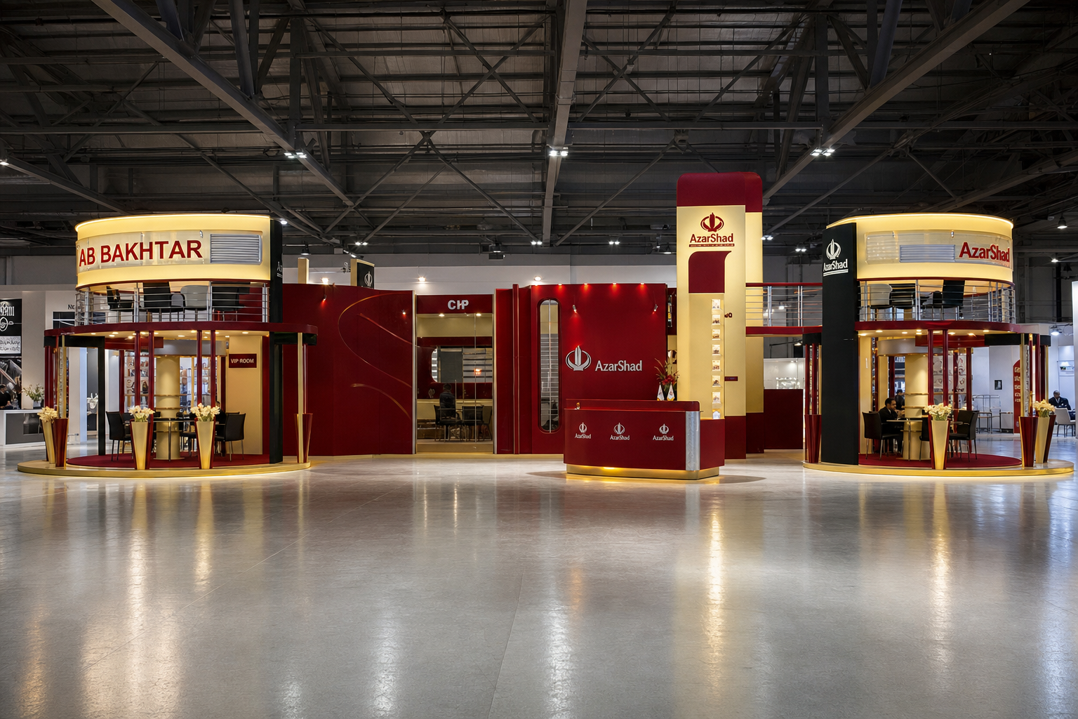 Front view of the AB Bakhtar exhibition stand with symmetrical circular meeting towers, deep red surfaces and illuminated gold details.