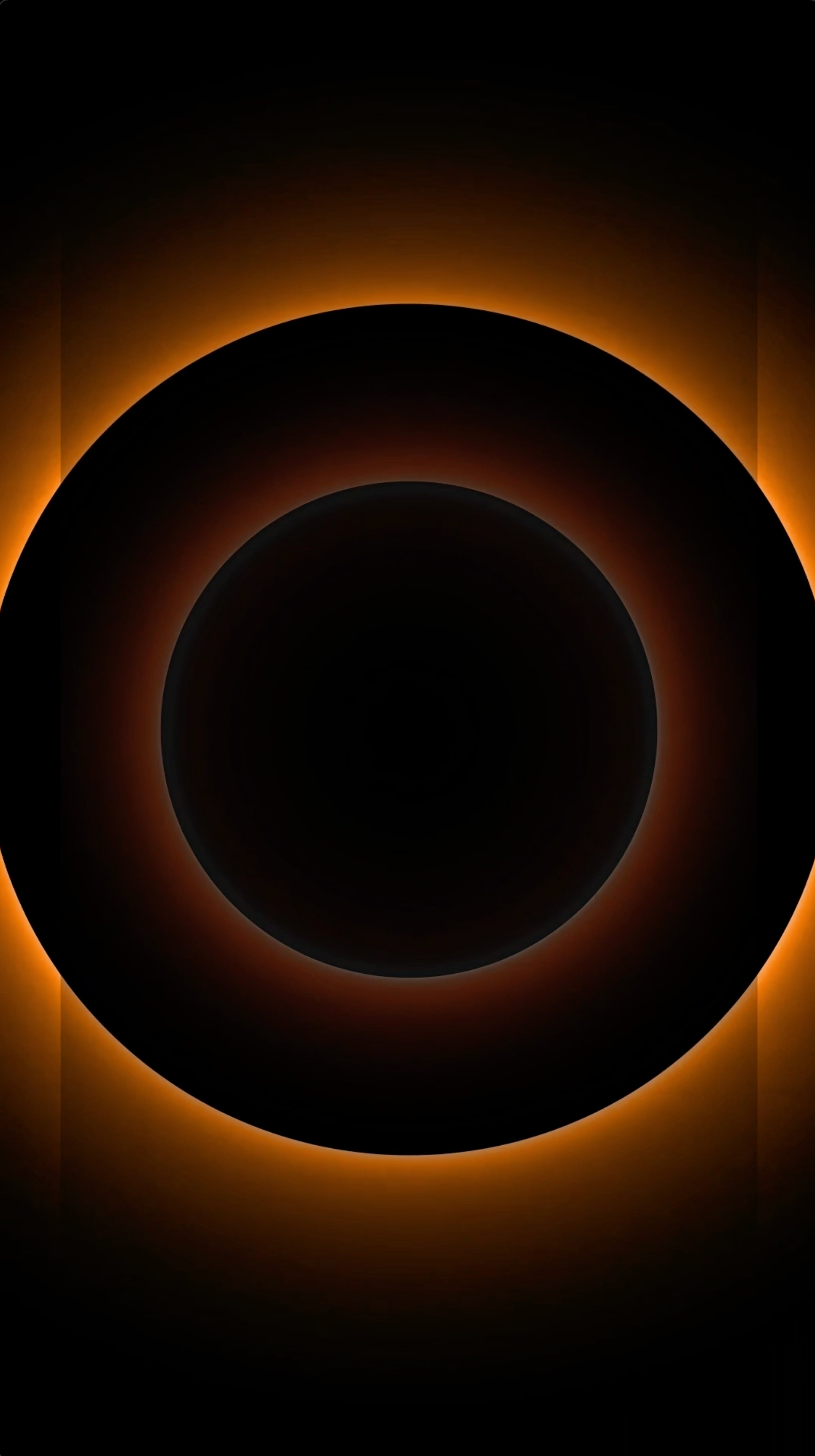Abstract moving-image artwork featuring dark circular forms gradually converging within a field of warm orange light against a predominantly black background.