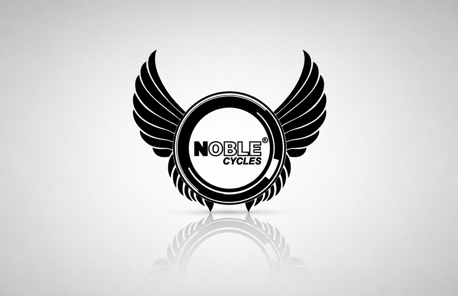 Noble Cycles logo featuring a black circular wheel-like emblem framed by symmetrical stylised wings. The Noble Cycles name appears in bold black lettering at the centre, presented on a white background.