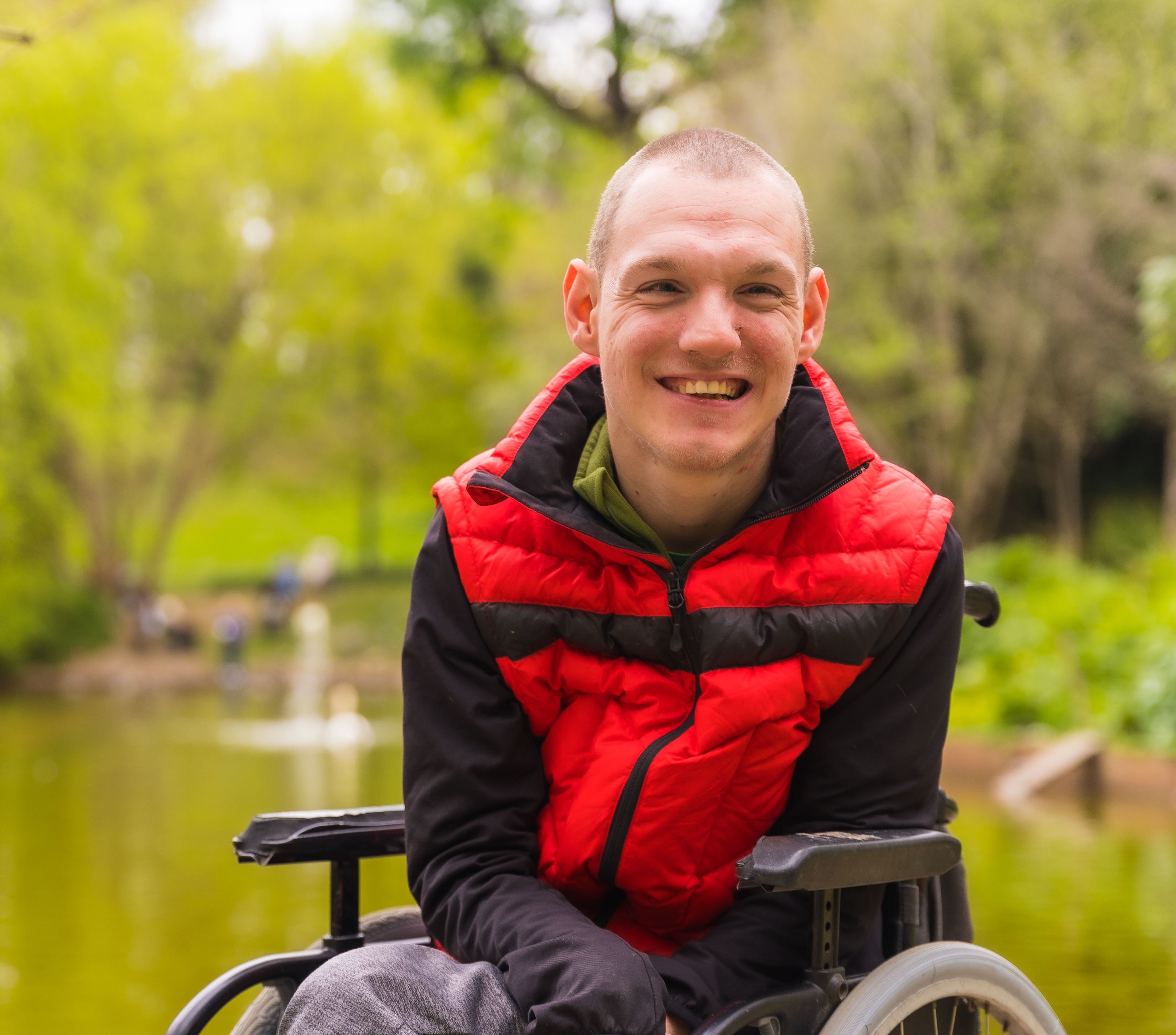 A man in a wheelchair in a park