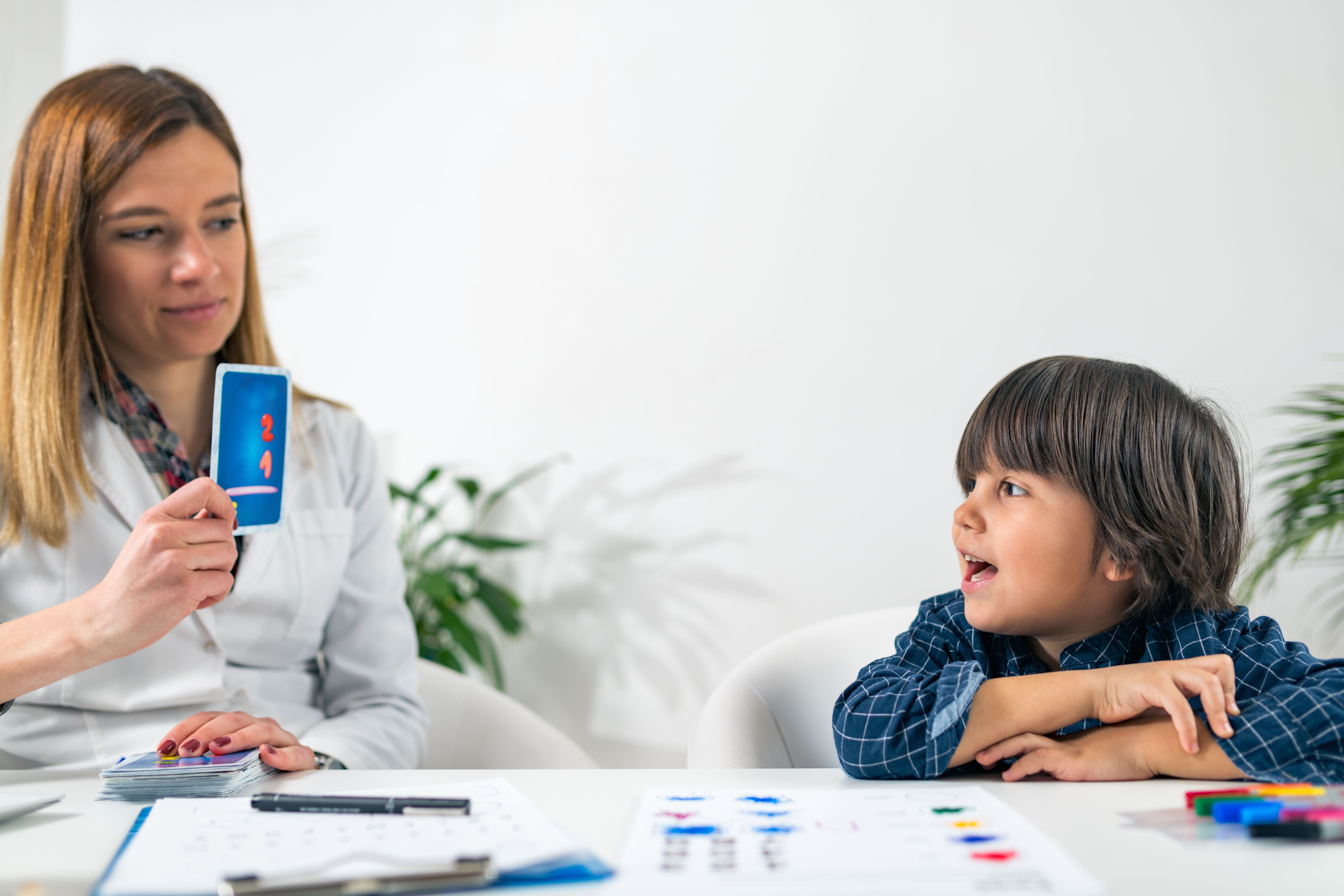 Clinician and toddler playing a game and undertaking a clinical assessment