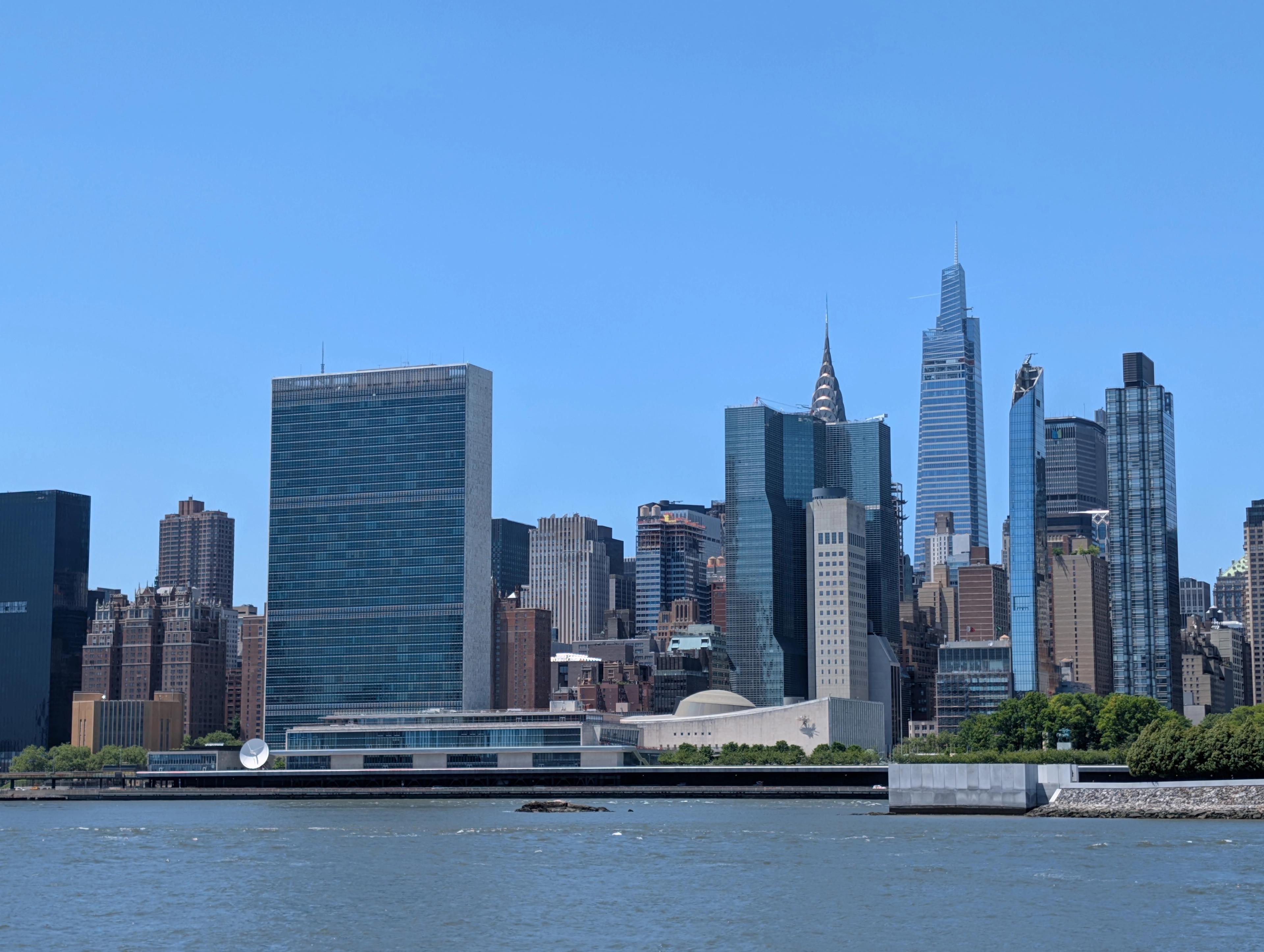 The United Nations Headquarters and United Nations Visitors Services buildings as viewed from Long Island City's Riverwalk park.