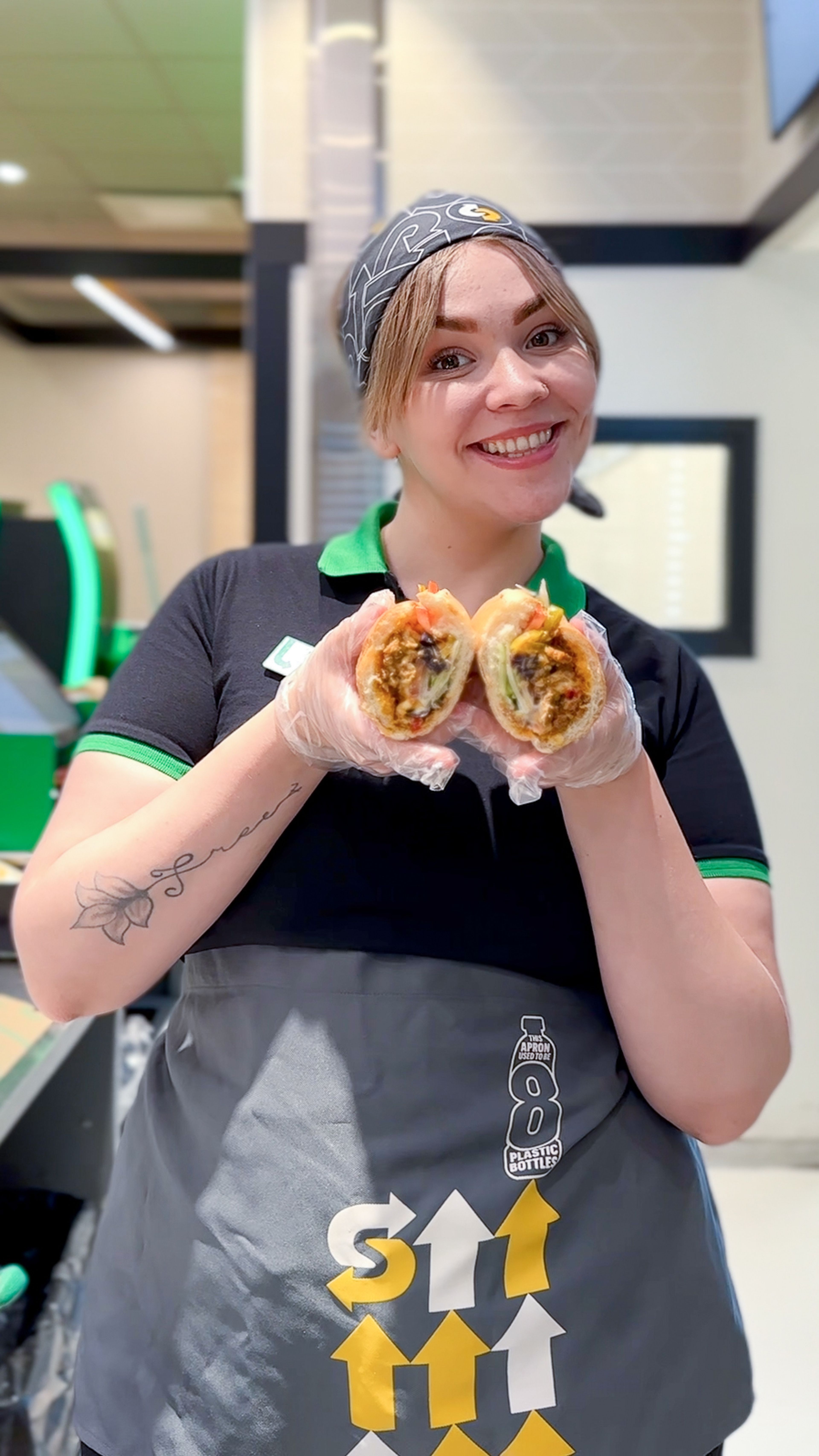 Image with sandwich artist and subs