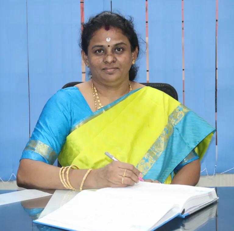 SMBM Matric Vice Principal seated at desk, posing formally in office setting.