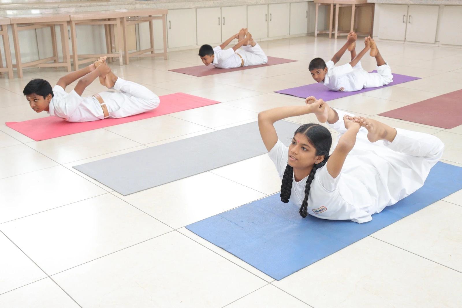 Students practicing yoga together to promote physical fitness and wellness.