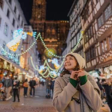 Christmas in Europe - lady smiling surrounded with lights