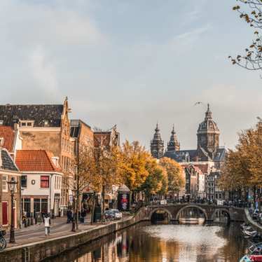 A canal view with Oude Kerk – the oldest building in Amsterdam – in the distance
