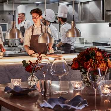 Chefs preparing food inside a London restaurant.