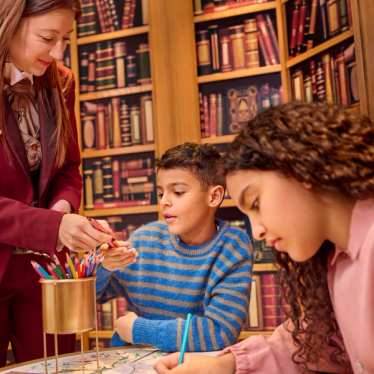 Family enjoying a creative activity with a host at Disney Paris during a summer trip with Eurostar.