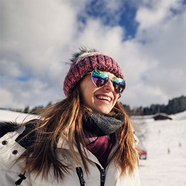 Smiling lady skiing in the French Alps