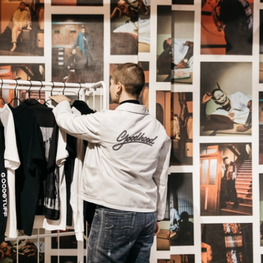 A woman at Goodhood sorting through a rack of clothes.