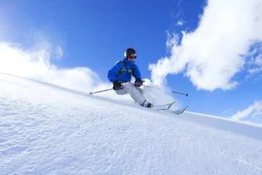 Skiing down a mountain in the Alps