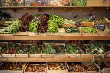 Ripe vegetables stacked side by side in rustic boxes - food market - Paris