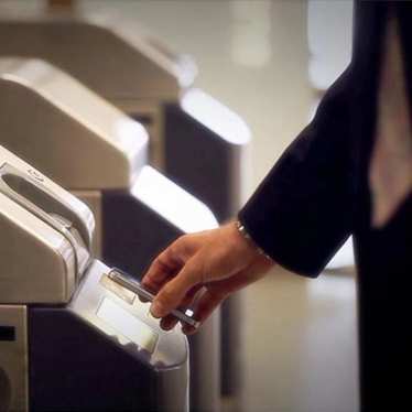 A man scanning his ticket at the Eurostar fast track gate