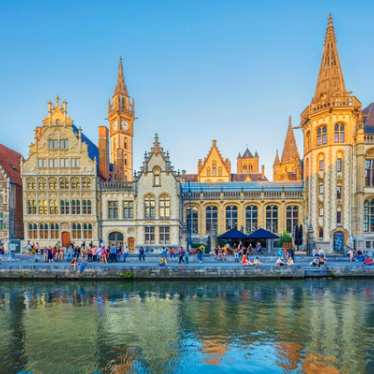 A view of people outside by a canal in Ghent.