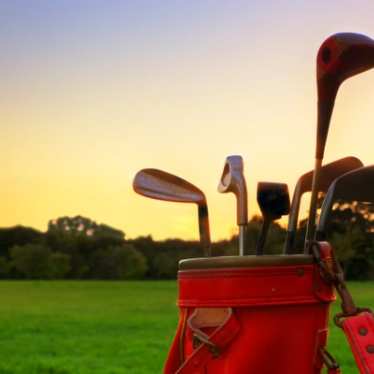 Golf clubs at sunset