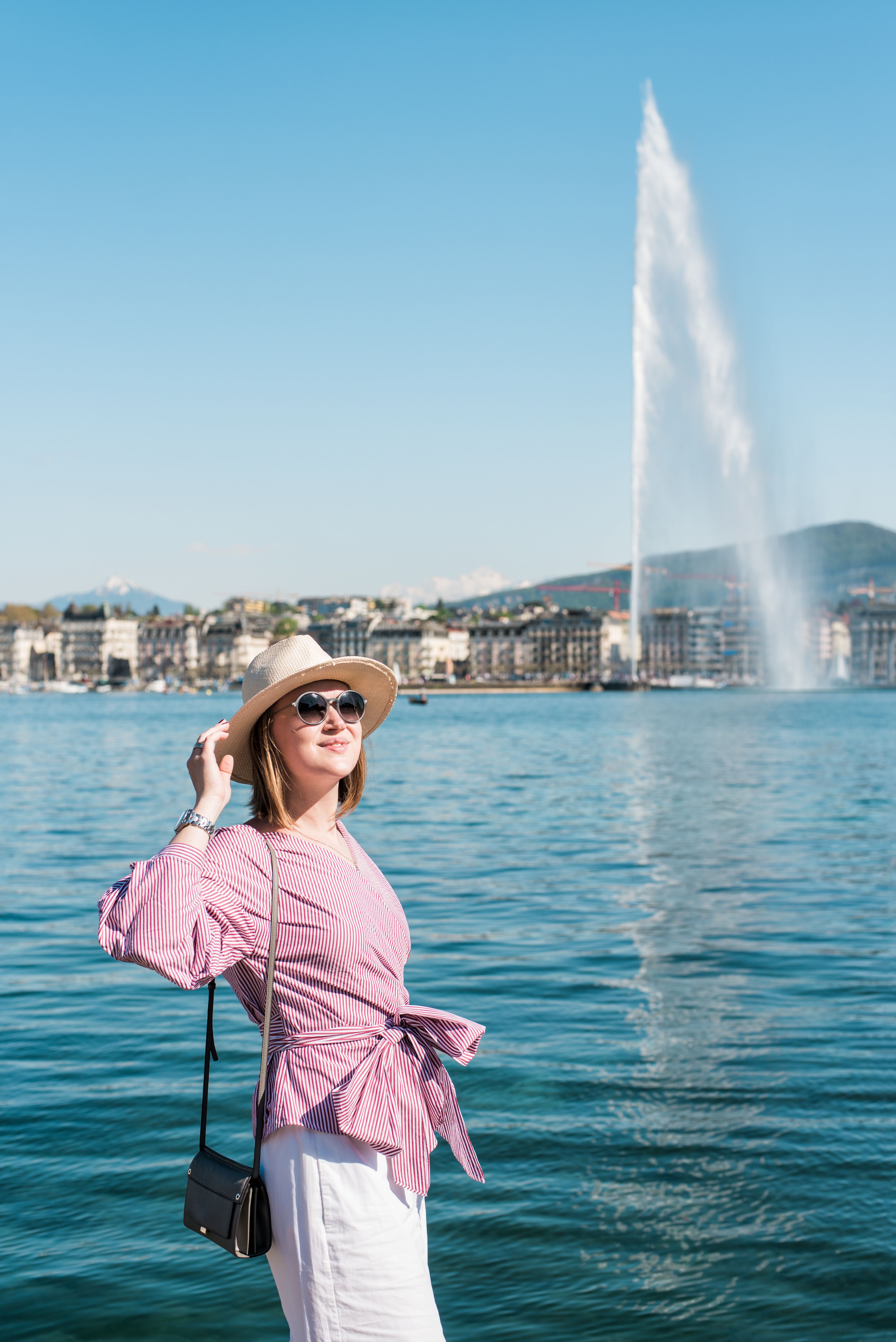 Lady holding her hat in Geneva, Switzerland
