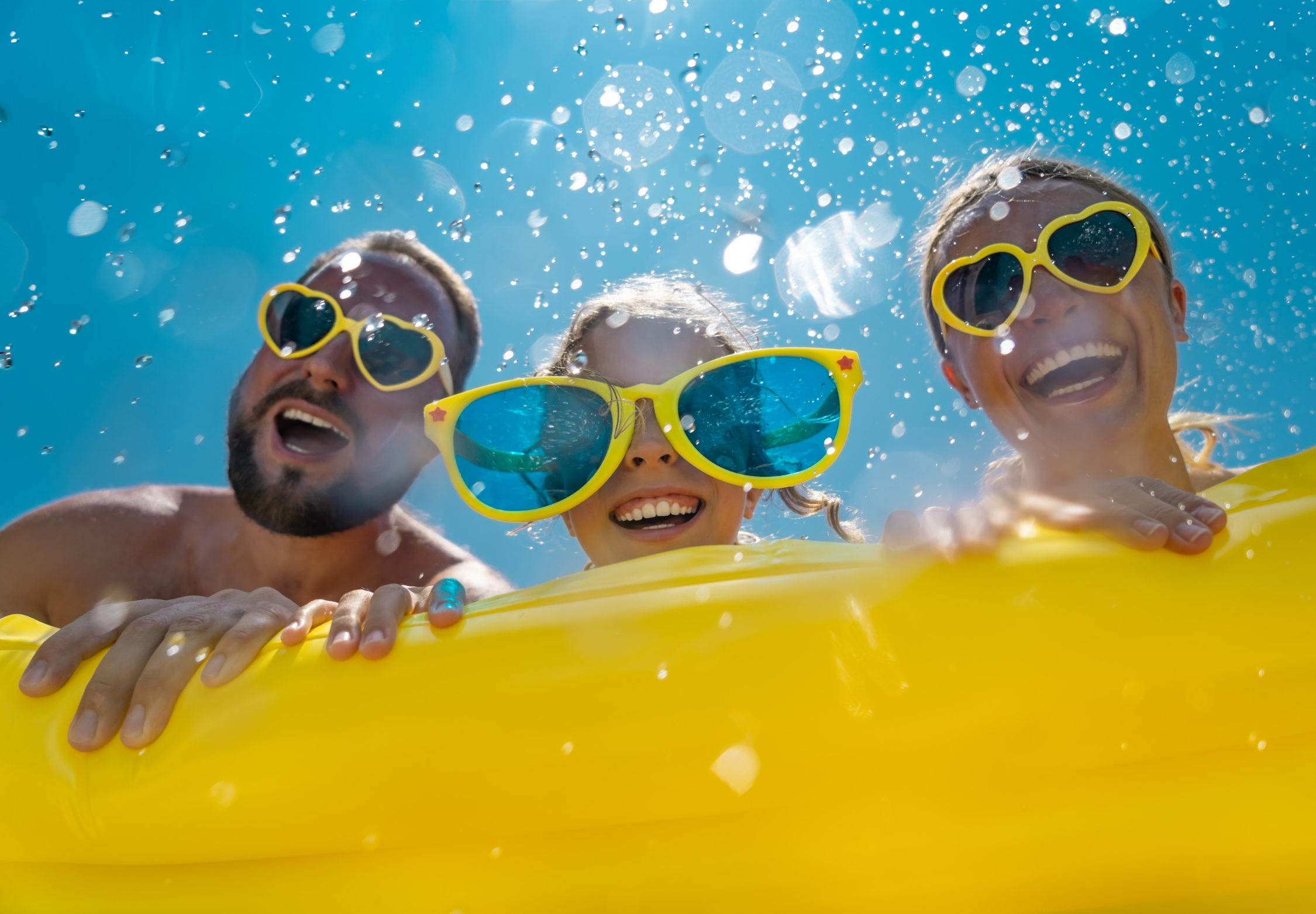 a family on a yellow rubber ring at Disney
