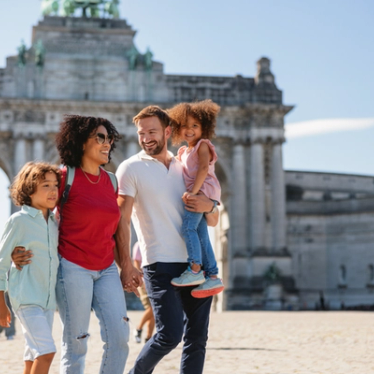 Belgium, Brussels - family walking in front of the Cinquantenaire Arch