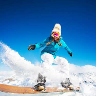 Lady on snow board in the Alps