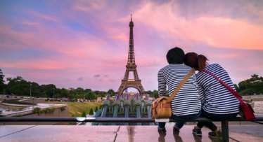 Couple at the Eiffel Tower in Paris at sunset