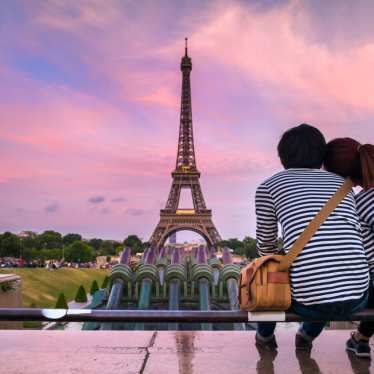 Couple at the Eiffel Tower in Paris at sunset