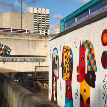 Wall art outside the National Film Theatre in London on a sunny day.