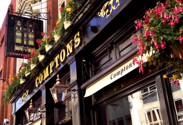 The outside of Comptons pub in London on a summer day.