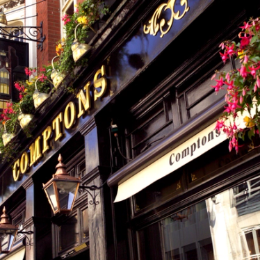 The outside of Comptons pub in London on a summer day.