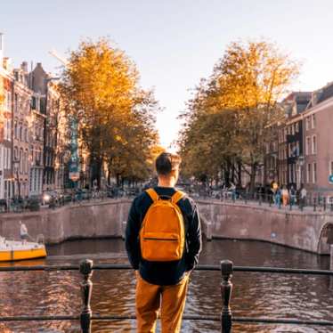 Amsterdam in Autumn, person looking out over canal