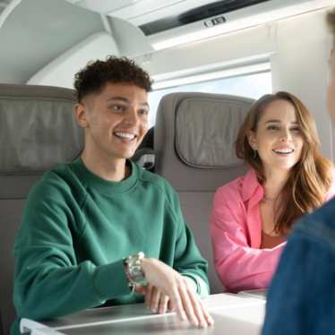 Eurostar train staff serving food to passengers.