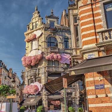 A café on a corner in Grand Sablon on a sunny day.