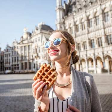 Brussels - Grand Place - Lady eating waffle