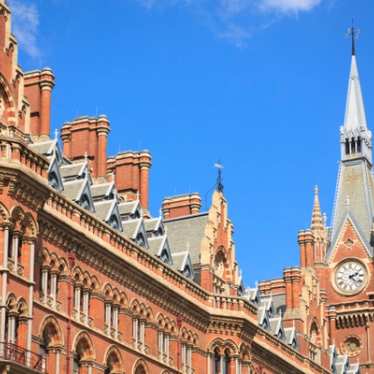 Clock tower of St Pancras International station on a sunny day.