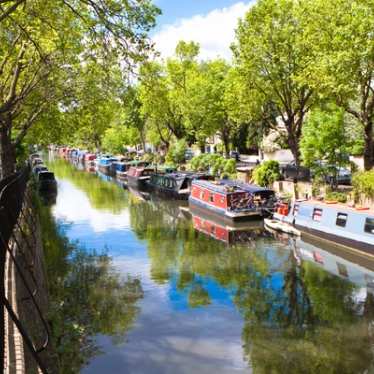 Boats along a canal on a sunny day.