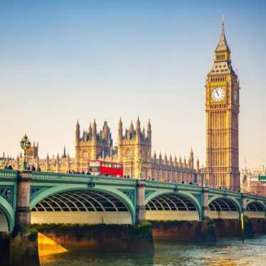 Big ben, and red bus going over river Thames in London