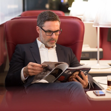 A man reading a magazine in Business Premier.