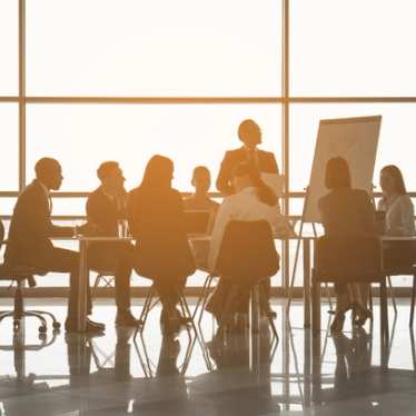 People sitting around a boardroom table.