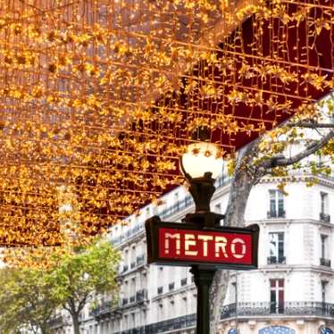 Paris at Christmas, metro sign with twinkling lights
