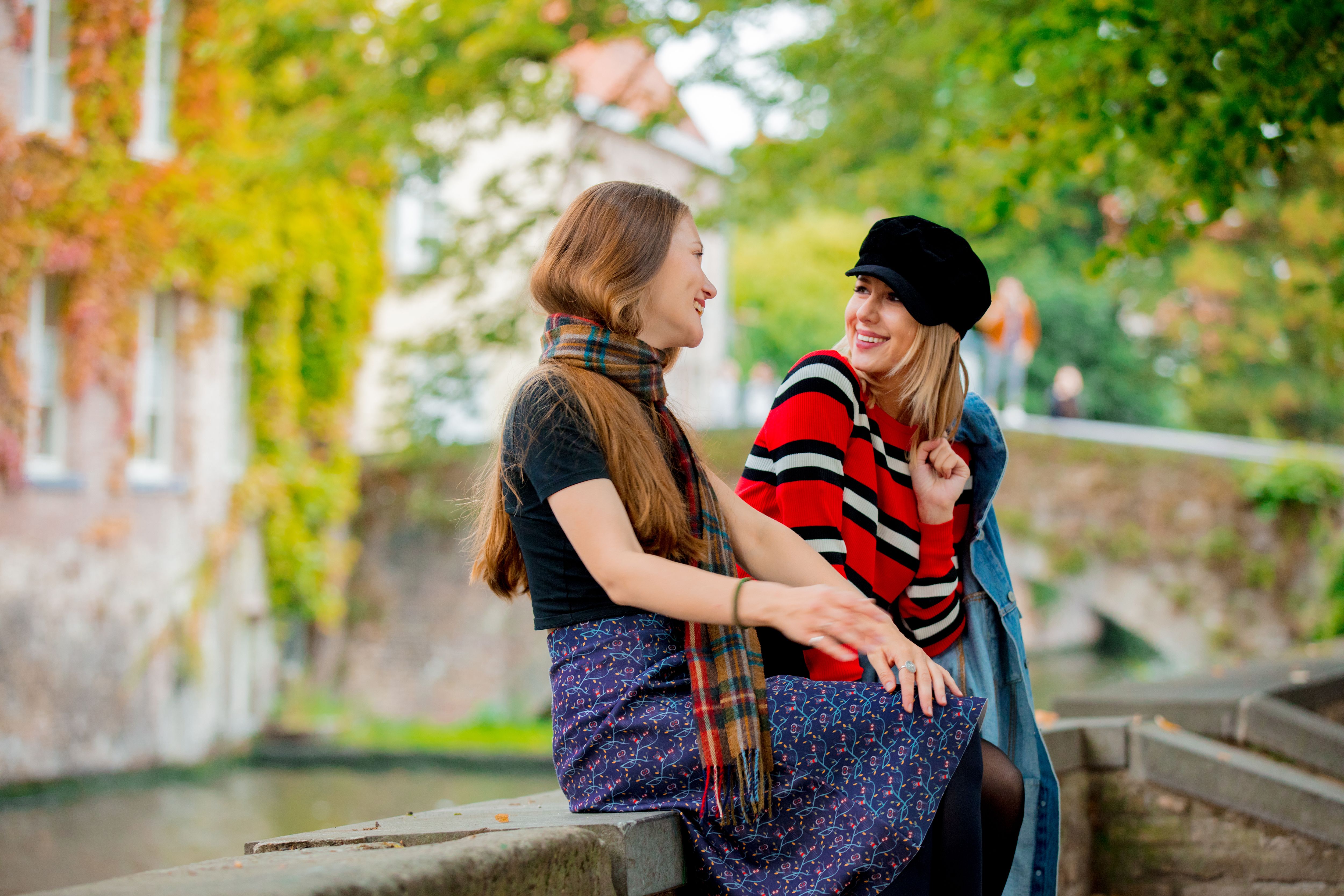 Friends talking by Bruges canal