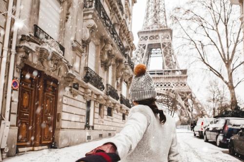 Paris - Eiffel Tower - winter snow - lady walking away